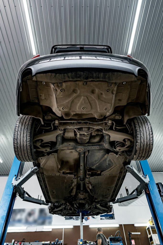 Сar in a car repair service lifted on a jack view from the bottom